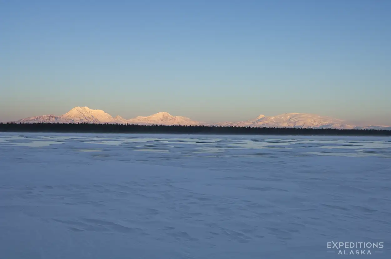 The Wrangell Mountains, including Mt Drum, Mt Sanford, Mt Zanetti and Mt Wrangell, from Willow Lake, frozen over and ice covered in winter, Wrangell-St. Elias National Park, Alaska.
