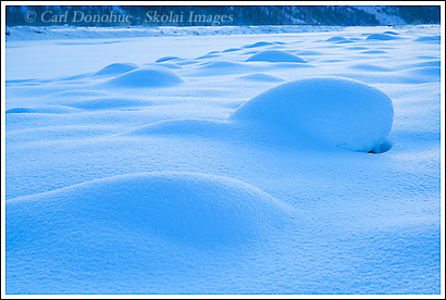 Snow covered rocks on the Kennecott River, winter, Wrangell St. Elias National Park, Alaska.