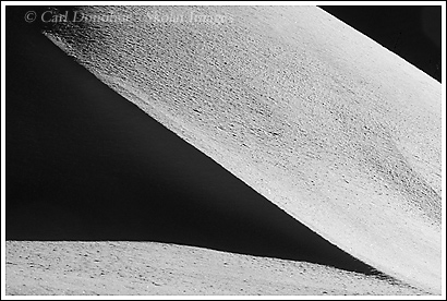 An Abstract photo, in black and white, of a snowbank or snow dune, showing shadows and light, winter, Wrangell-St. Elias National Park, Alaska.
