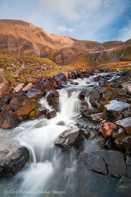 A waterfall in the high alpine mountain country of Wrangell-St. Elias National Park and Preserve, Alaska.