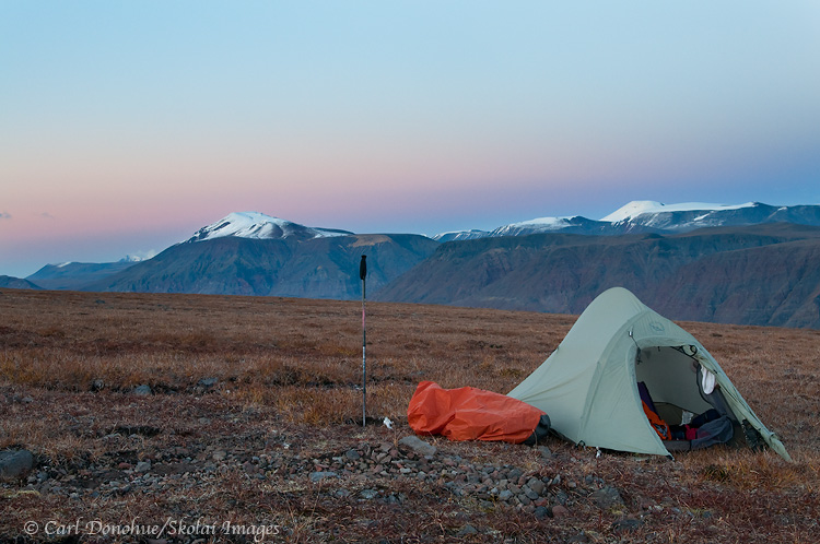 A backcountry campsite high on the tundra in the Wrangell Mountains. The high alpine ridges near Mt Jarvis, Wrangell-St. Elias National Park and Preserve provide a great place for hiking and backpacking. Sunset, Wrangell-St. Elias National Park and Preserve, Alaska.