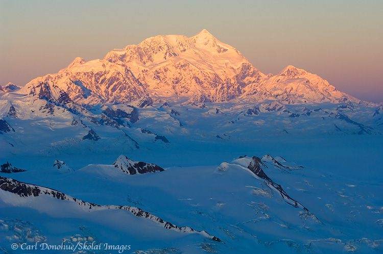 Mount Saint Elias, 18 008' high,catches the last of the sun's rays for the day, Wrangell-St. Elias National Park and Preserve, Alaska | aerial photo.
